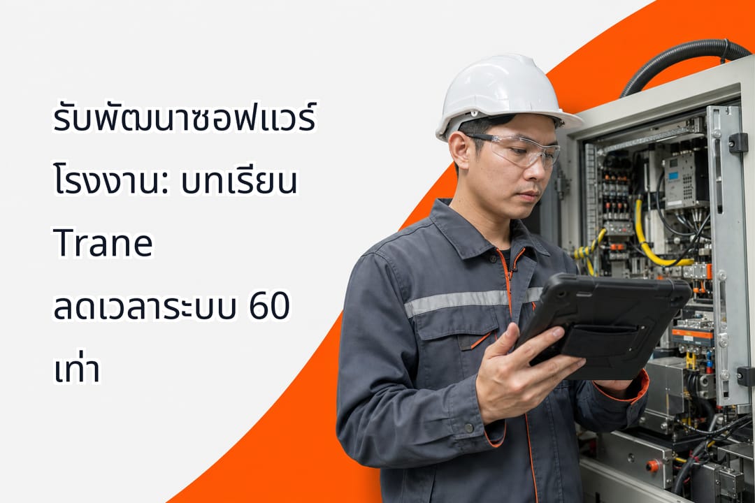 A maintenance technician holding an industrial tablet near an open control panel of a manufacturing machine inside a modern Thai factory floor